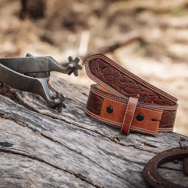 A brown full grain leather belt for women featuring tooled floral pattern 